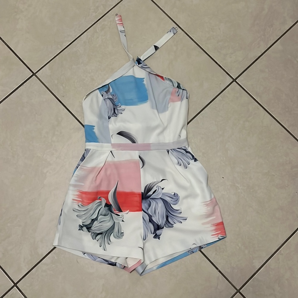 casual spring dress is white is blue, pink and orange detailing.